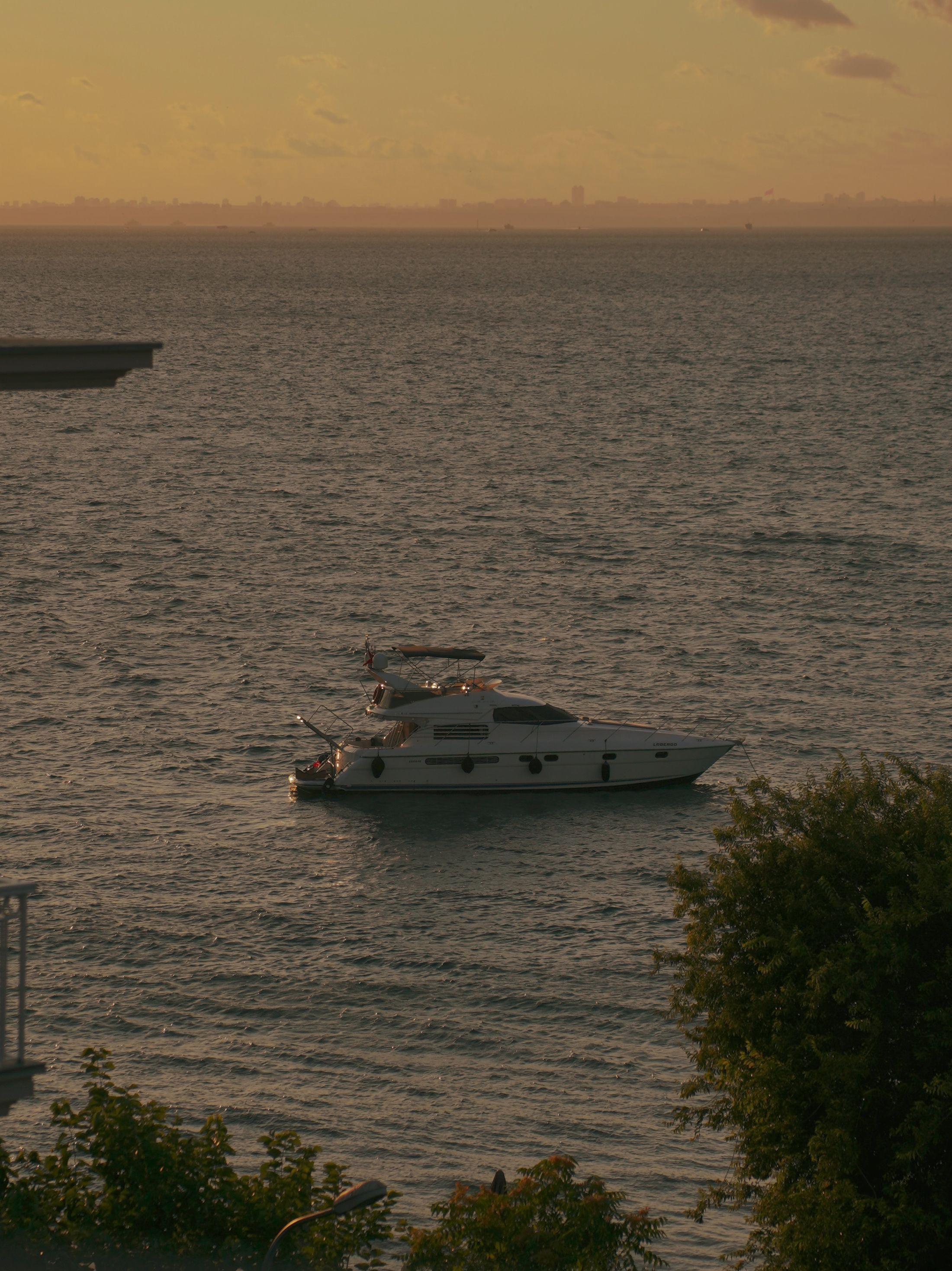 Yacht resting on open water in warm evening light